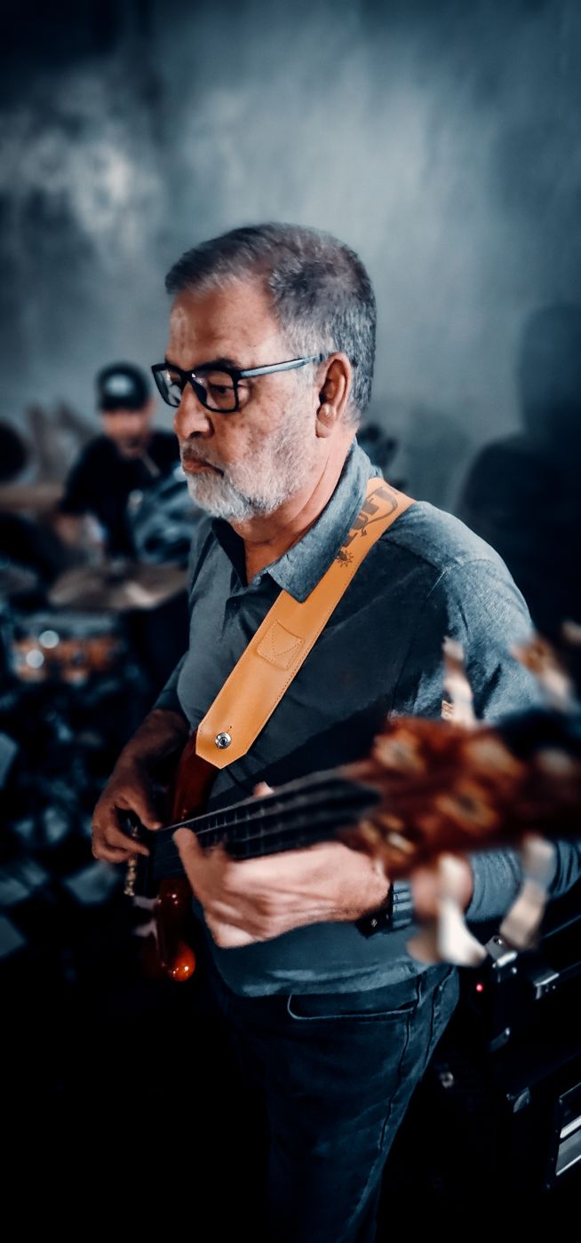 Guitarist in glasses with a sunburst guitar