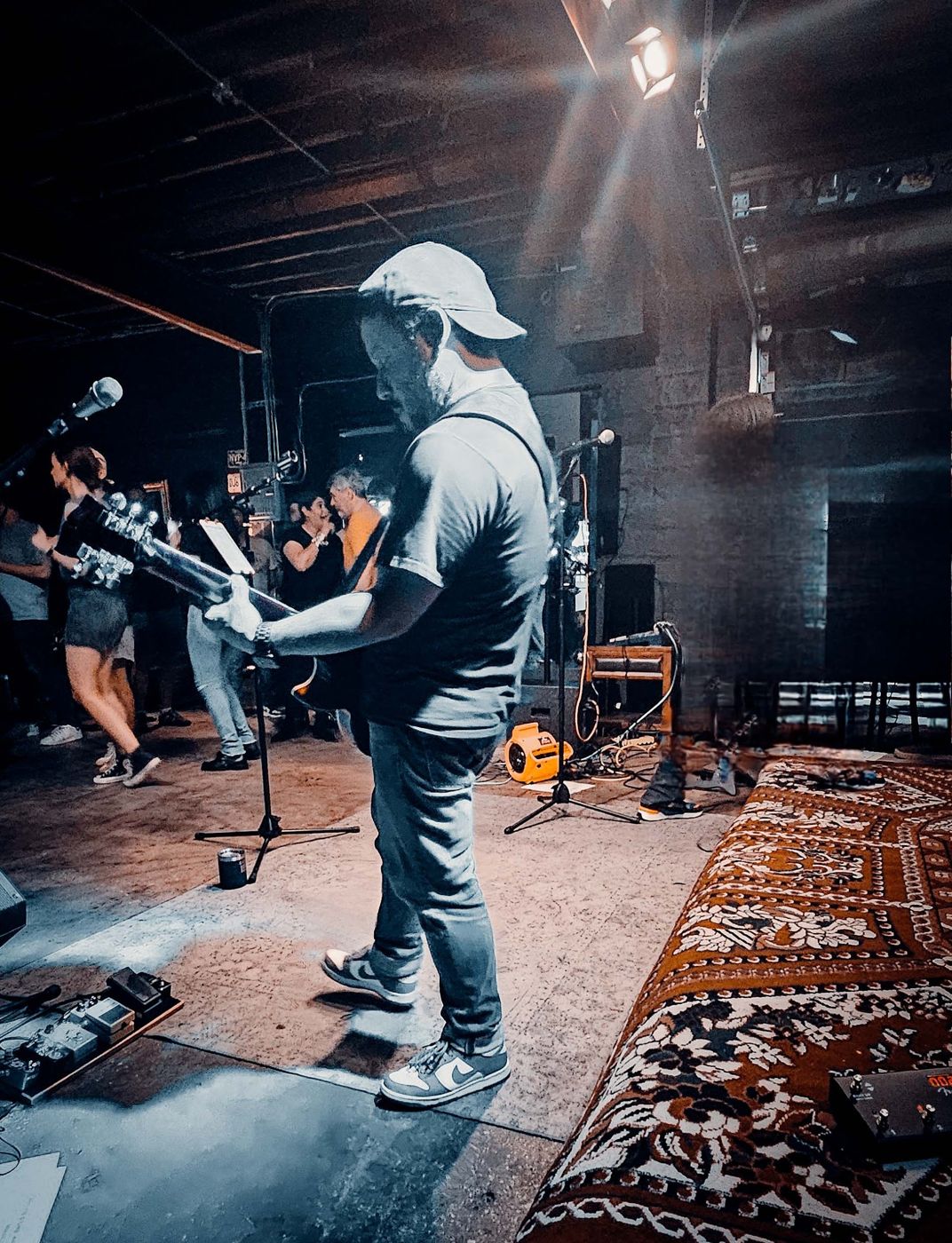 Guitarist in a cap in the rug room