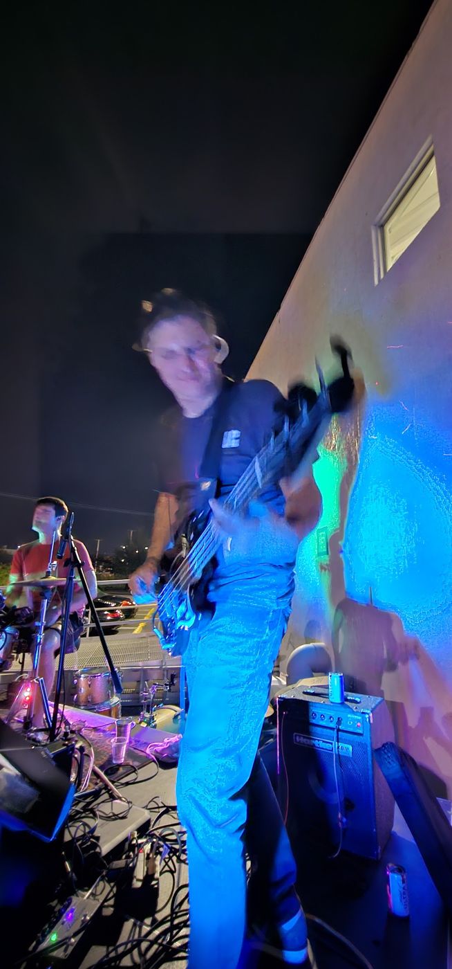 Guitarist in blue light on the outdoor stage