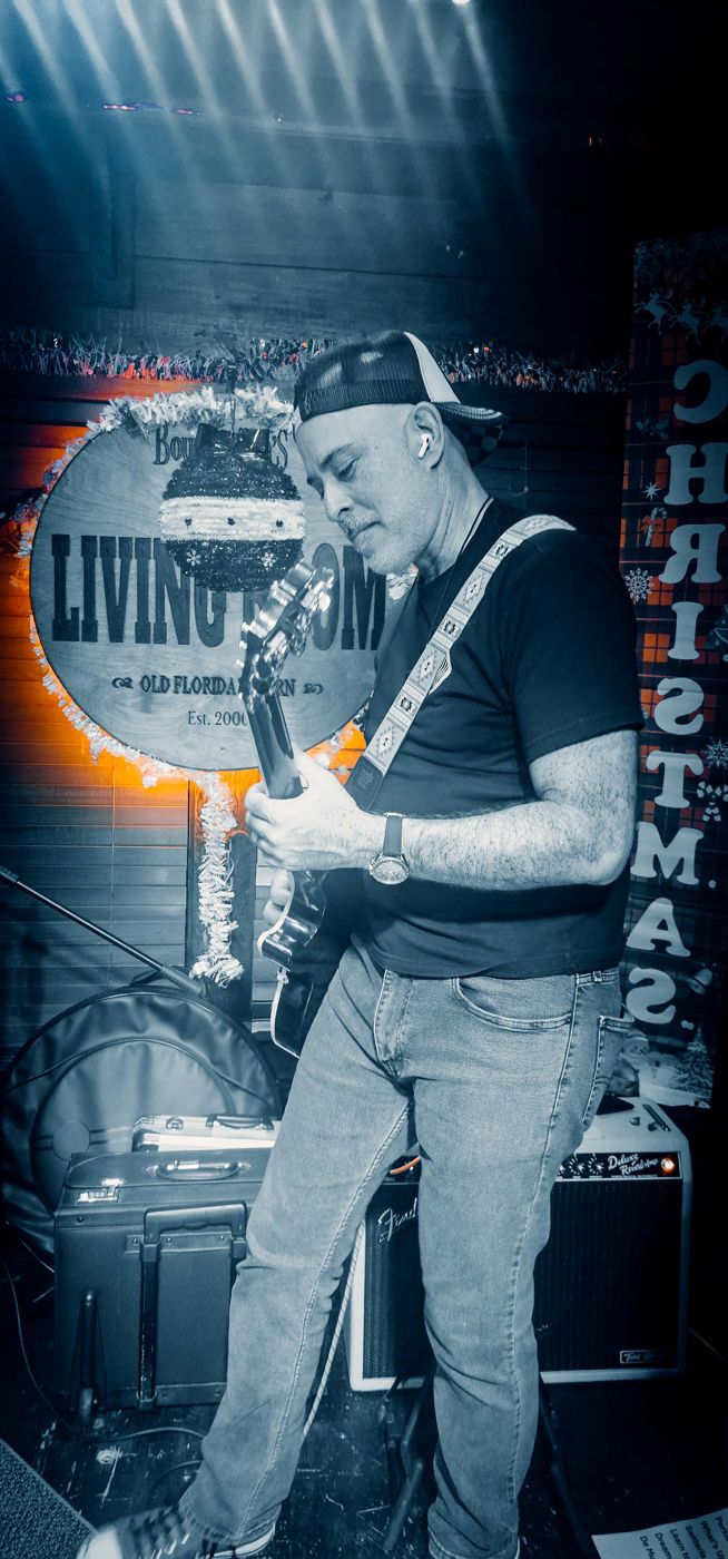 Guitarist in a cap at a holiday show