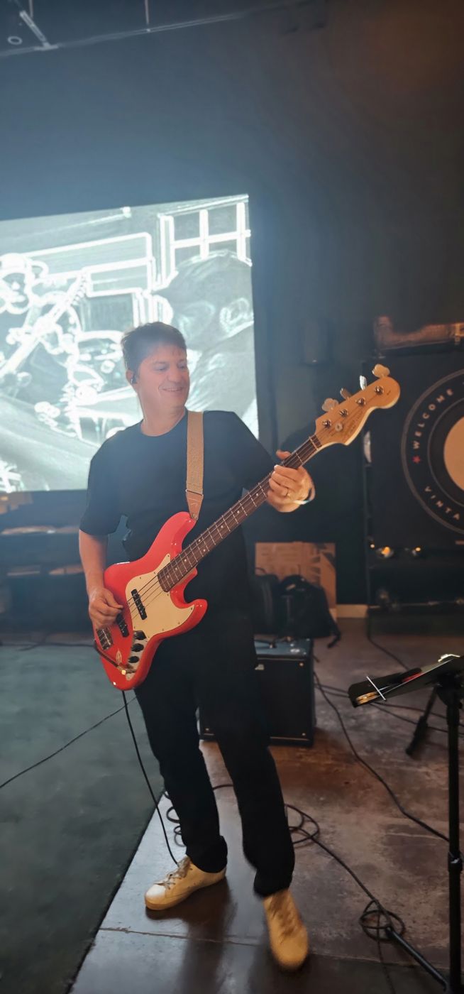 Bass player in front of the projection screen