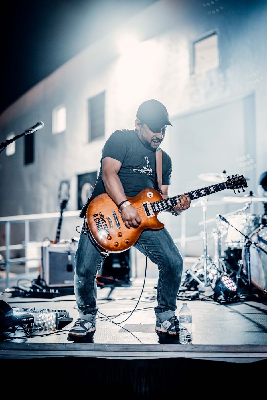 Guitarist under the lights at an outdoor night show