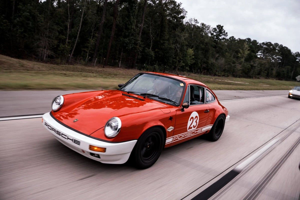 Orange classic with race number 23 on the highway