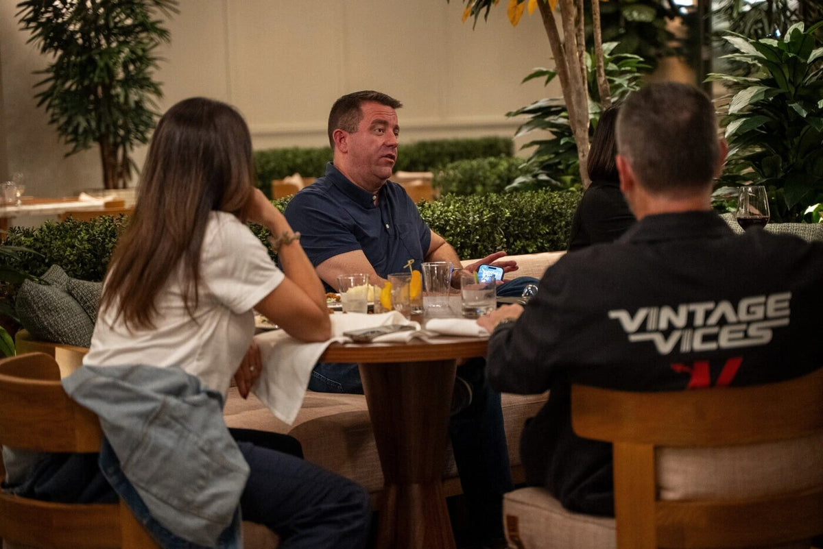 Guests at dinner, one in a Vintage Vices jacket